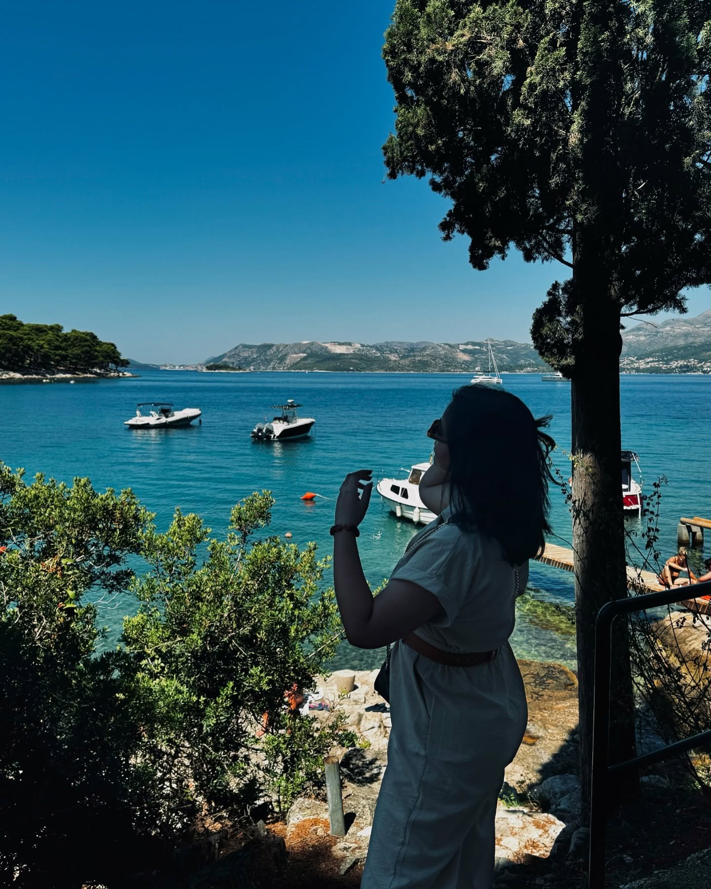Maryam overlooking a blue coastline